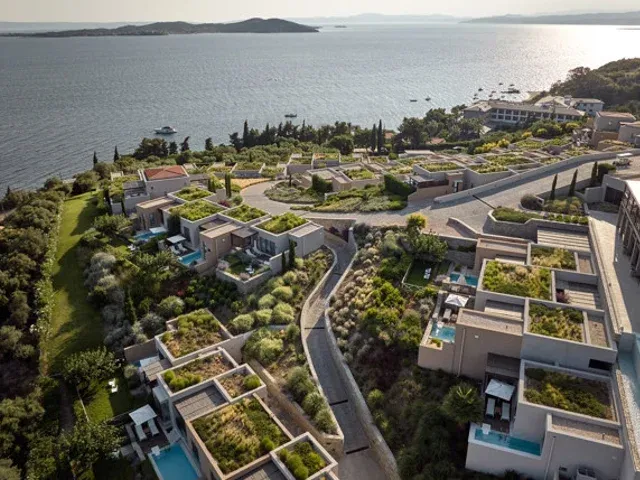 Eagles Resort villas on a green hillside above the sea