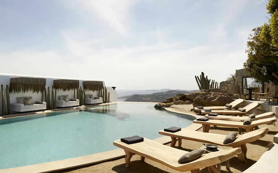 Myconian Collection on Mykonos: an infinity pool with cabanas over the coast