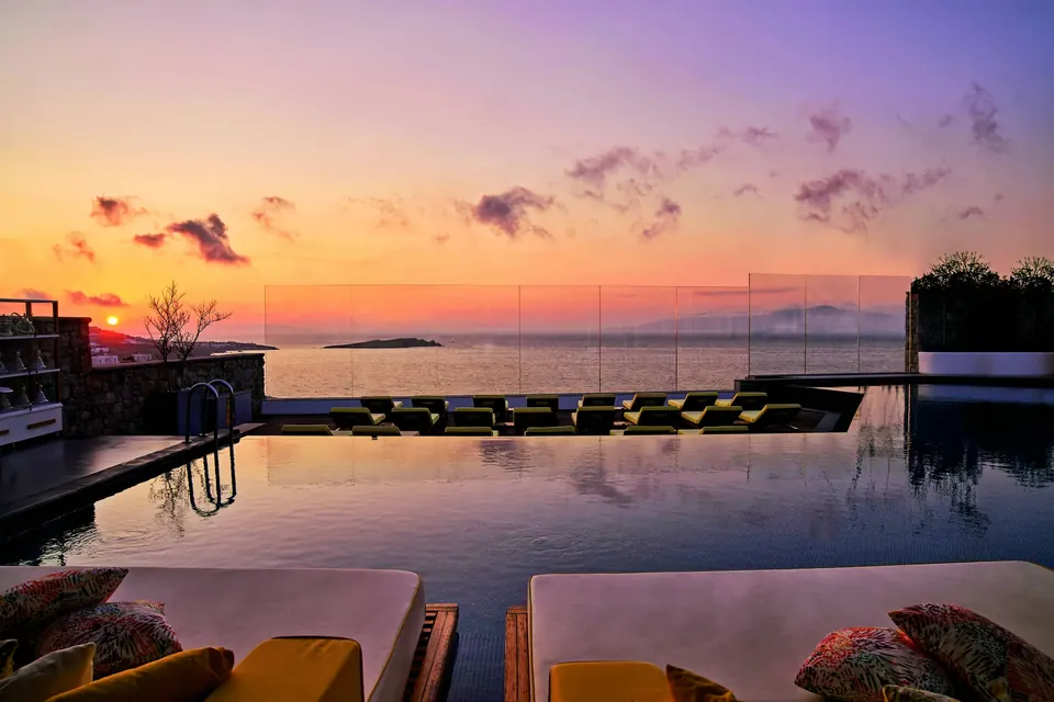 Myconian Collection on Mykonos: an infinity pool at sunset over the Aegean